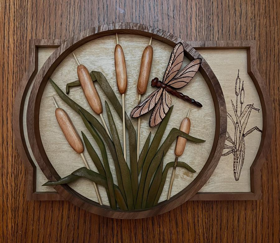 Intarsia dragonfly with cattails in a walnut frame