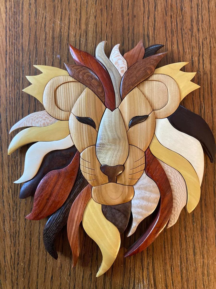 Intarsia lion wall hanging in mixed hardwoods